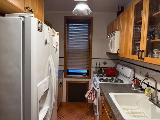 a kitchen with stainless steel appliances granite countertop a refrigerator and a stove