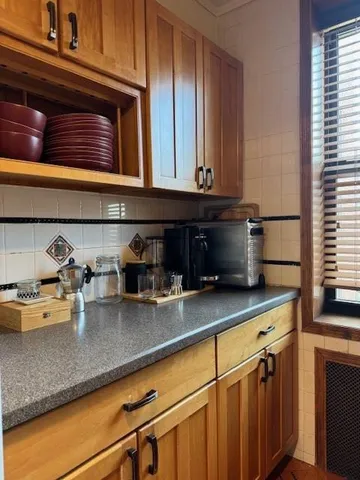 a kitchen with appliances cabinets and a counter top space