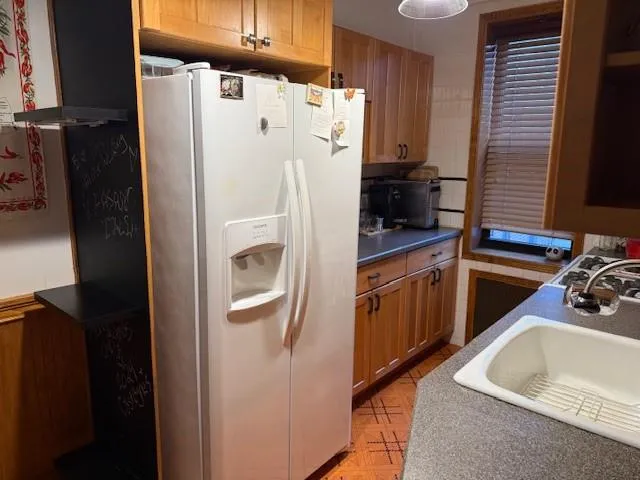 a kitchen with stainless steel appliances granite countertop a refrigerator and a sink