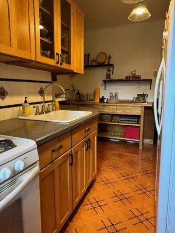 a kitchen with stainless steel appliances granite countertop a sink and a stove
