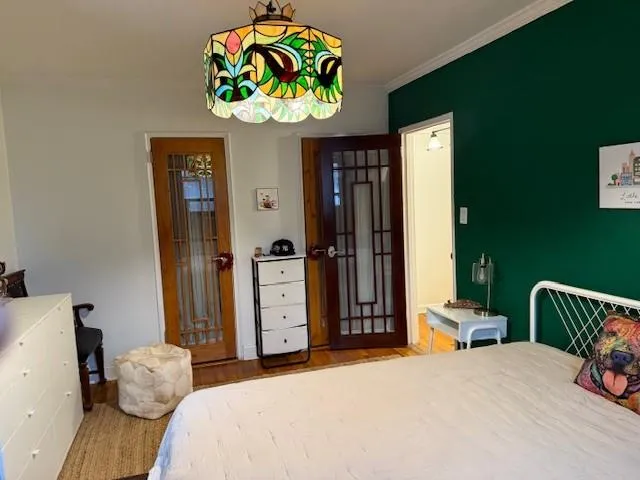 a bedroom with a bed and a chandelier