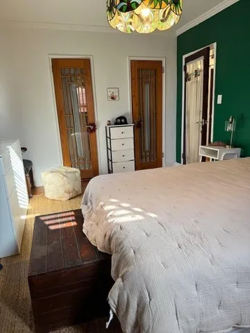 a bedroom with a bed and dresser