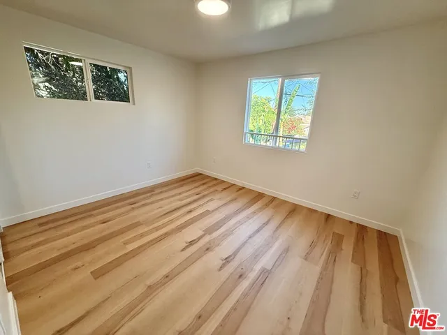 a view of a room that has a bed and a window