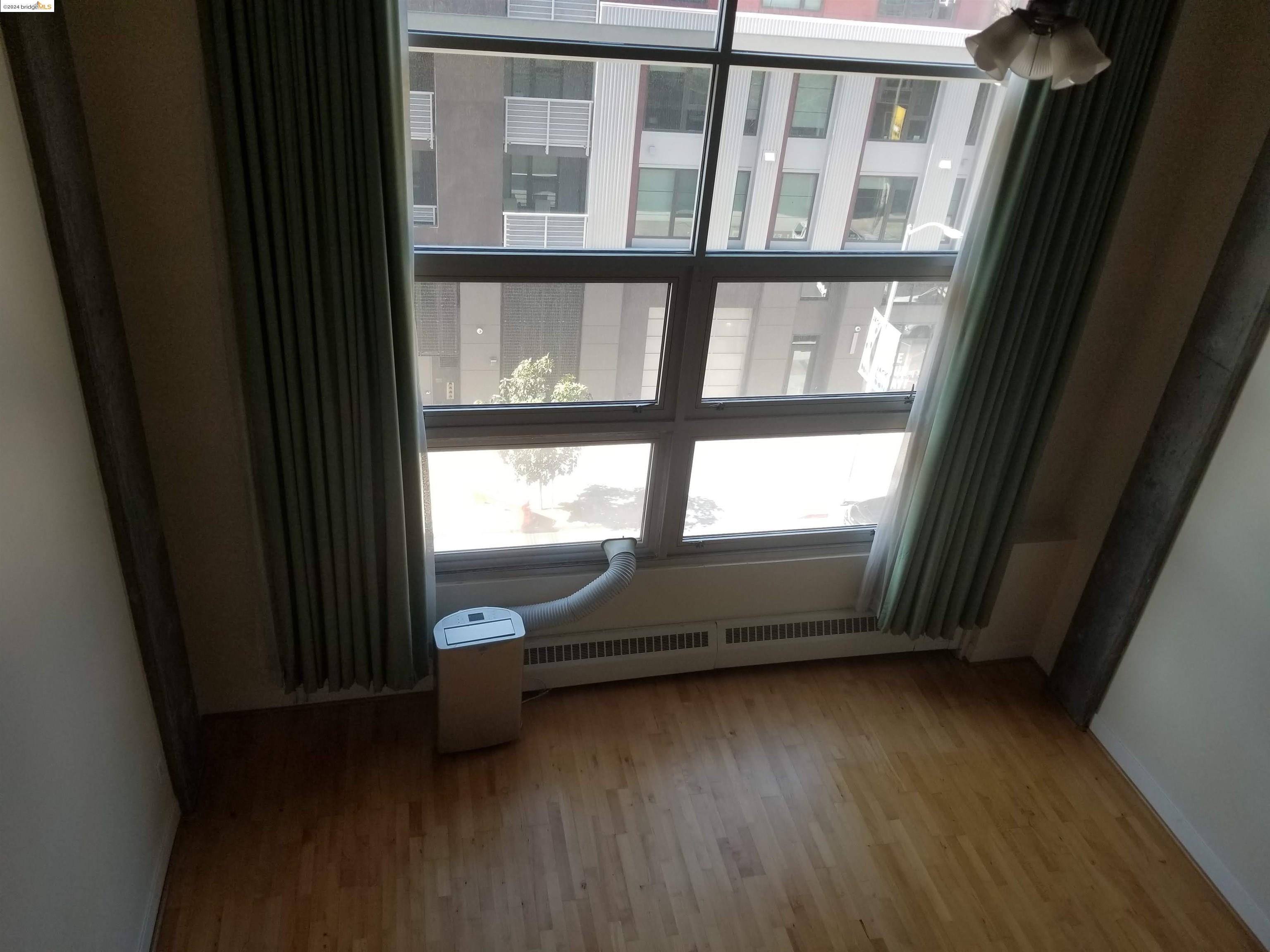 311 Oak Street, Unit 540 Oakland, CA 94607 - Photo 3 of 21 a view of an empty room with a window