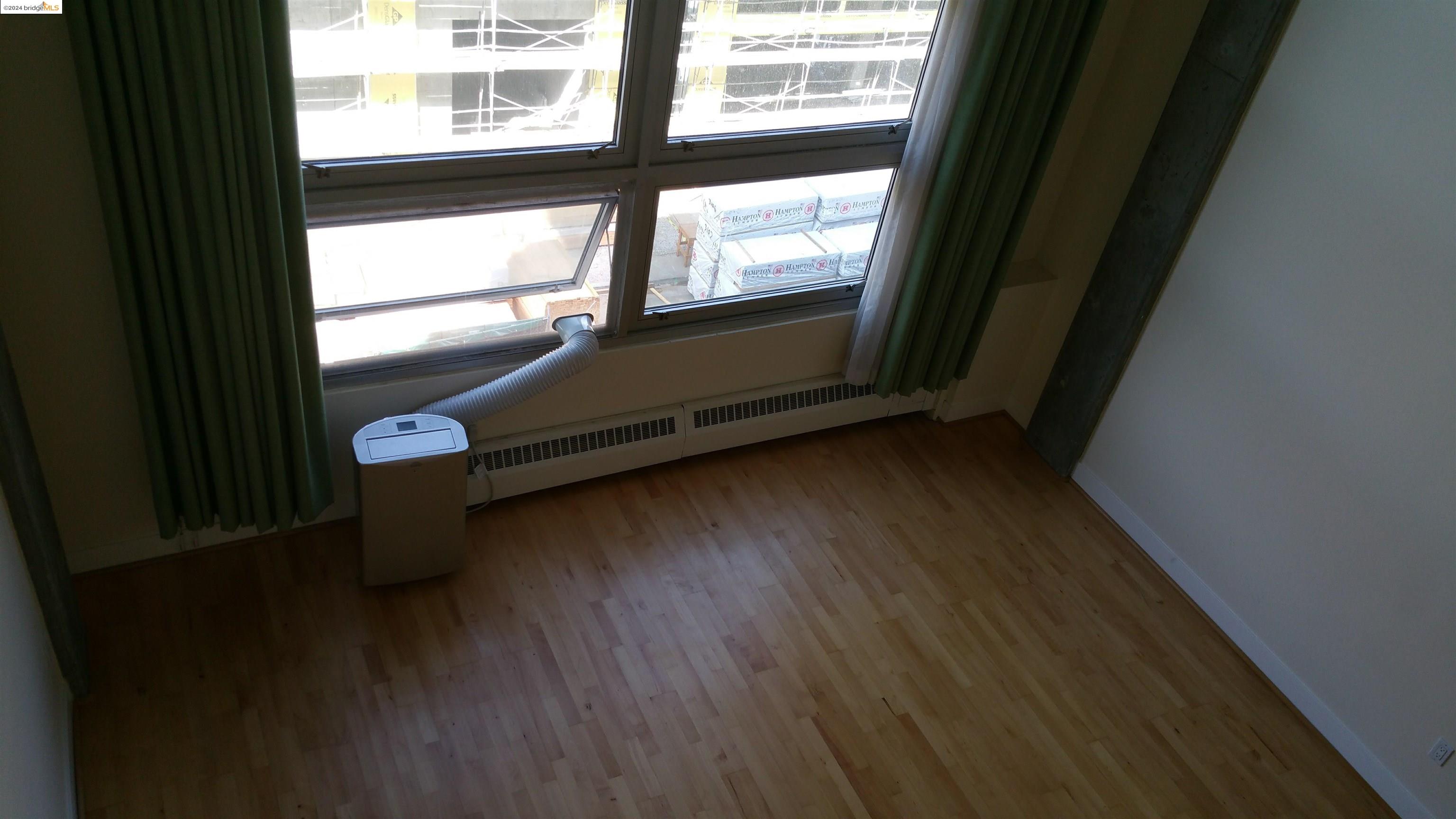 311 Oak Street, Unit 540 Oakland, CA 94607 - Photo 4 of 21 a view of a room with wooden floor and windows