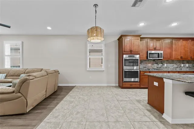 a living room with couches and a flat screen tv