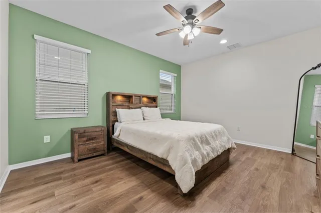 a bedroom with a bed tv and a chandelier