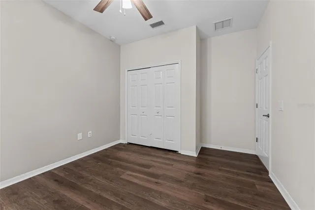 a utility room with granite countertop cabinets washer and dryer