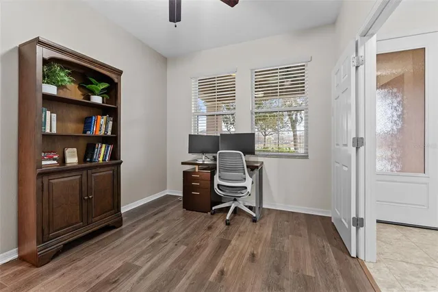 a view of a workspace with furniture and a window