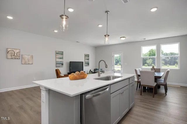 a kitchen with a sink and chairs
