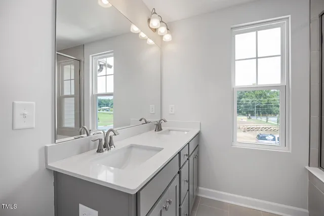 a bathroom with a sink vanity and a mirror