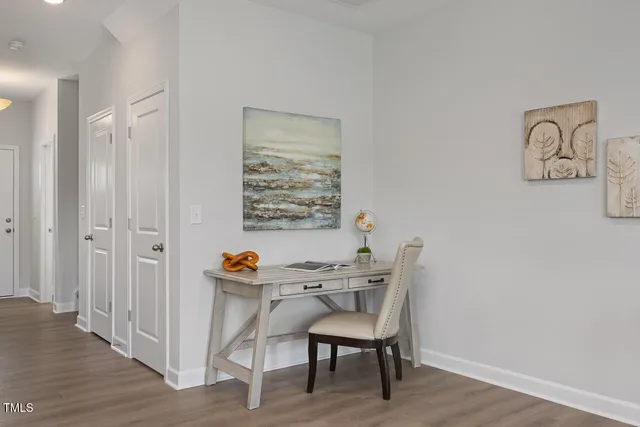 a dining room with furniture and wooden floor