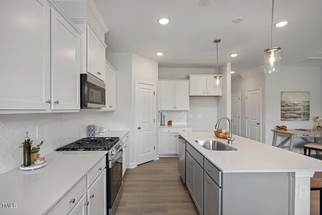 a kitchen with a sink stove and wooden cabinets