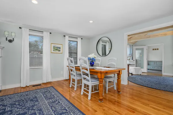a living room with furniture a rug and a large window