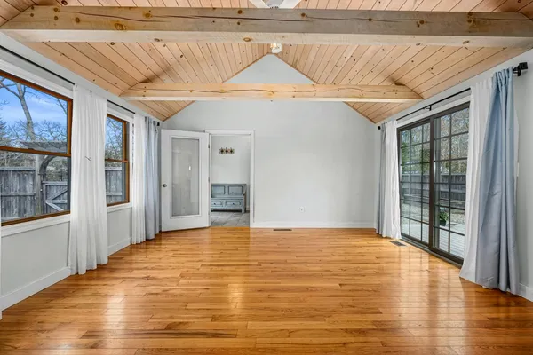 a bed sitting in a bedroom next to a window