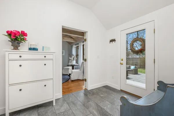a bed sitting in a bedroom next to a window