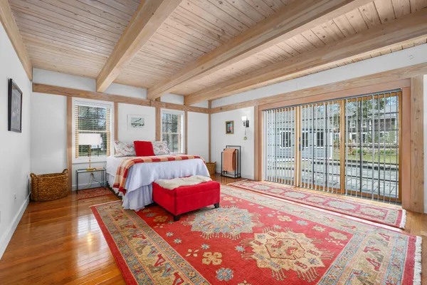 a view of an empty room window and wooden floor