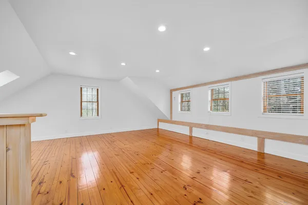 a bedroom with a bed window and a table