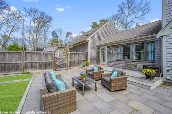 a front view of a house with a yard and sitting area