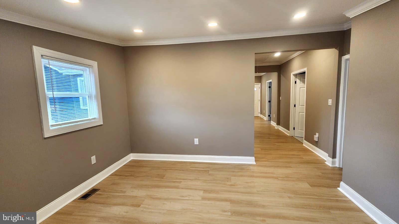 1407 Sunken Road Fredericksburg, VA 22401 - Photo 13 of 39 a view of an empty room with wooden floor and a window