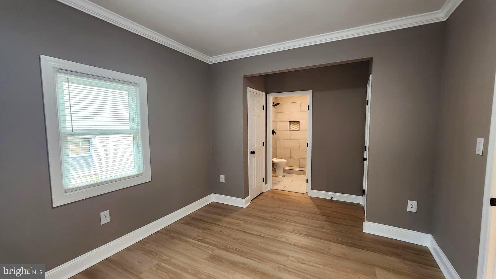 1407 Sunken Road Fredericksburg, VA 22401 - Photo 24 of 39 a view of an empty room with wooden floor and a window