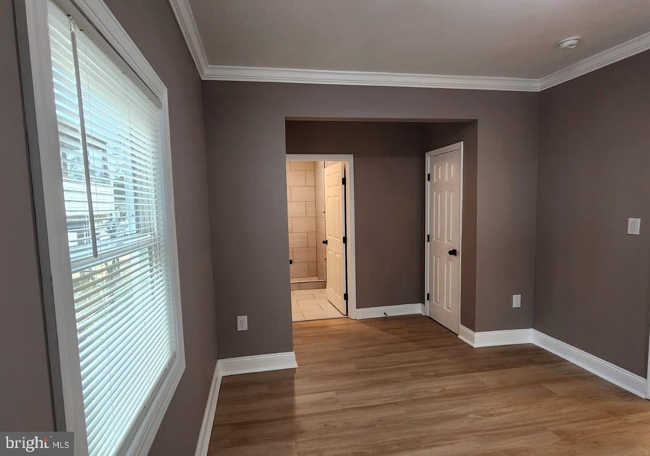 1407 Sunken Road Fredericksburg, VA 22401 - Photo 25 of 39 a view of an empty room with wooden floor and a window