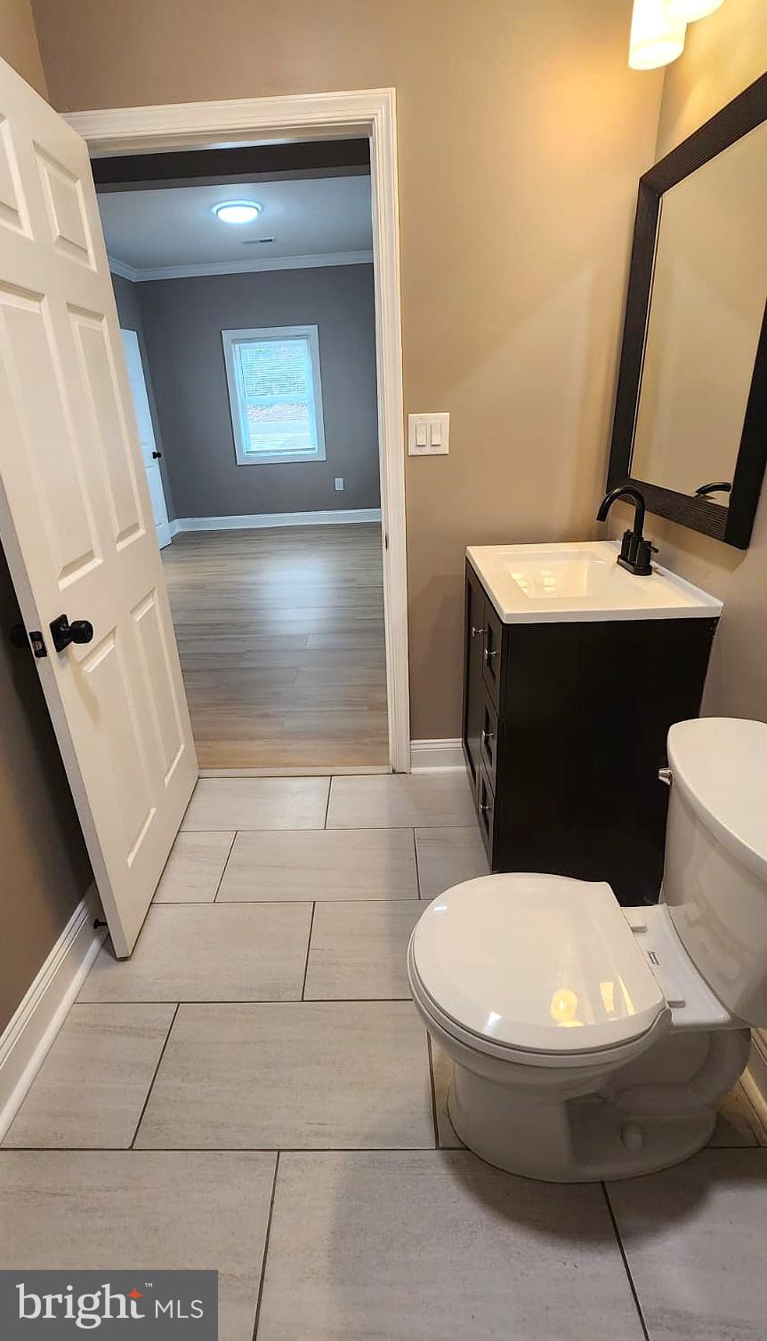 1407 Sunken Road Fredericksburg, VA 22401 - Photo 27 of 39 a bathroom with a toilet a sink and mirror