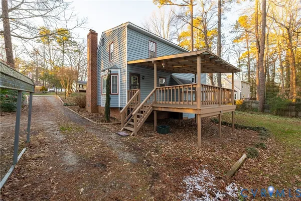 a wooden bench sitting in front of a house