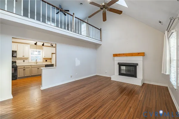 a view of a kitchen with wooden floor and a kitchen