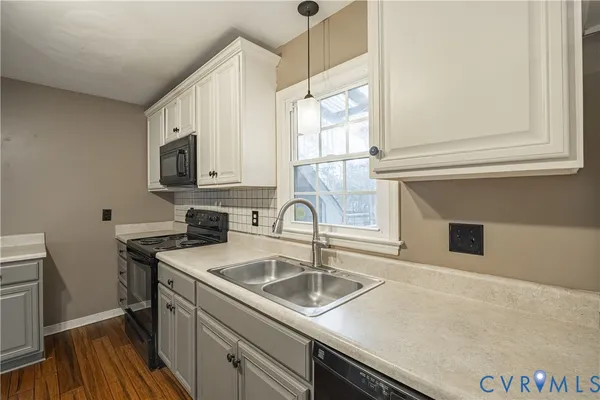 a kitchen with a sink and a stove top oven