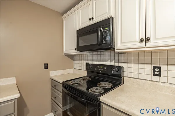 a kitchen with a stove and a microwave