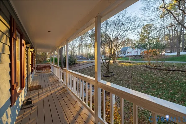 a view of balcony with wooden floor and fence