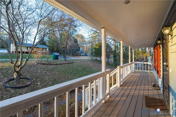 a view of a porch with wooden floor and outdoor space