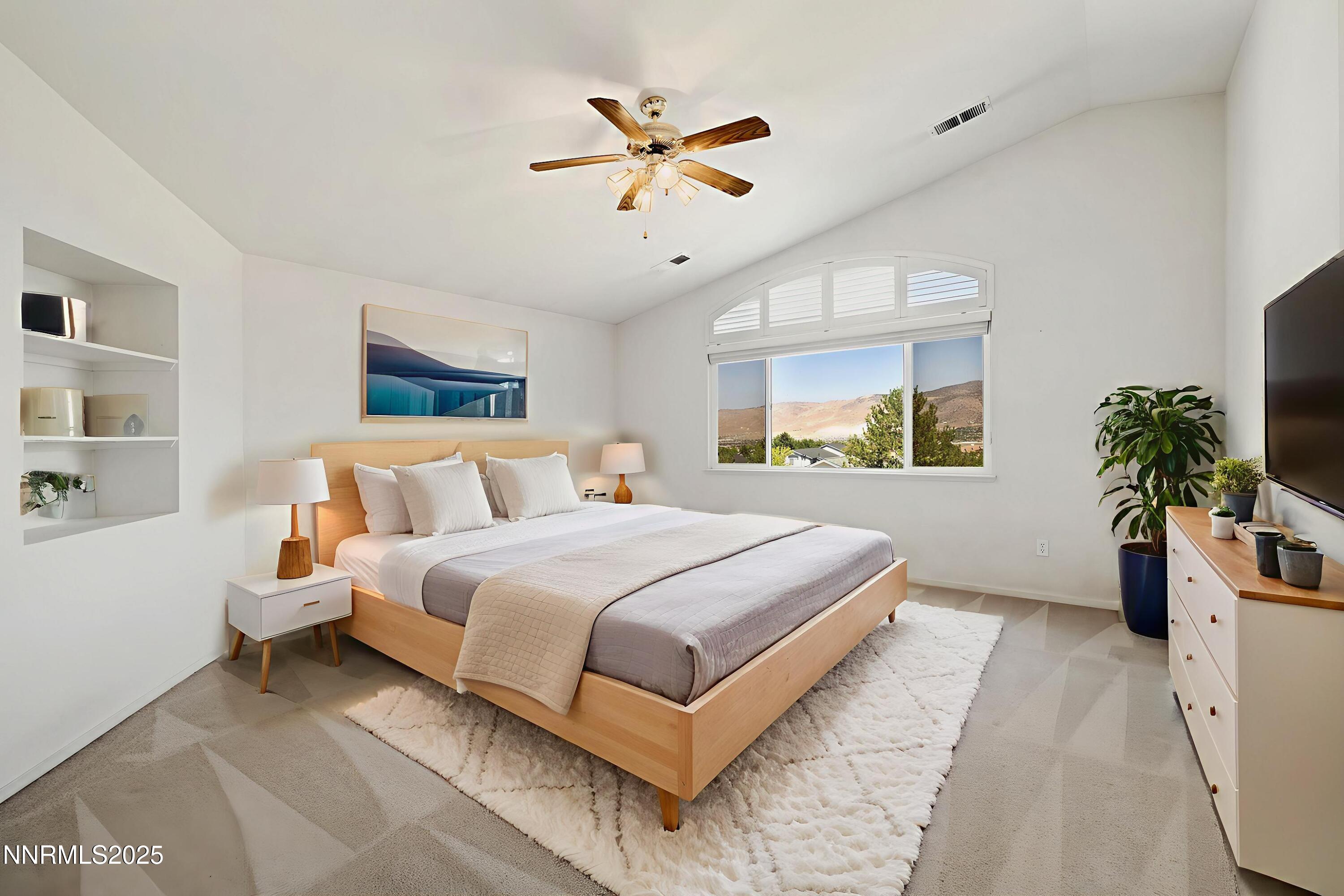 14330 Ghost Rider Drive Reno, NV 89511 - Photo 12 of 41 a bedroom with a large bed and a chandelier
