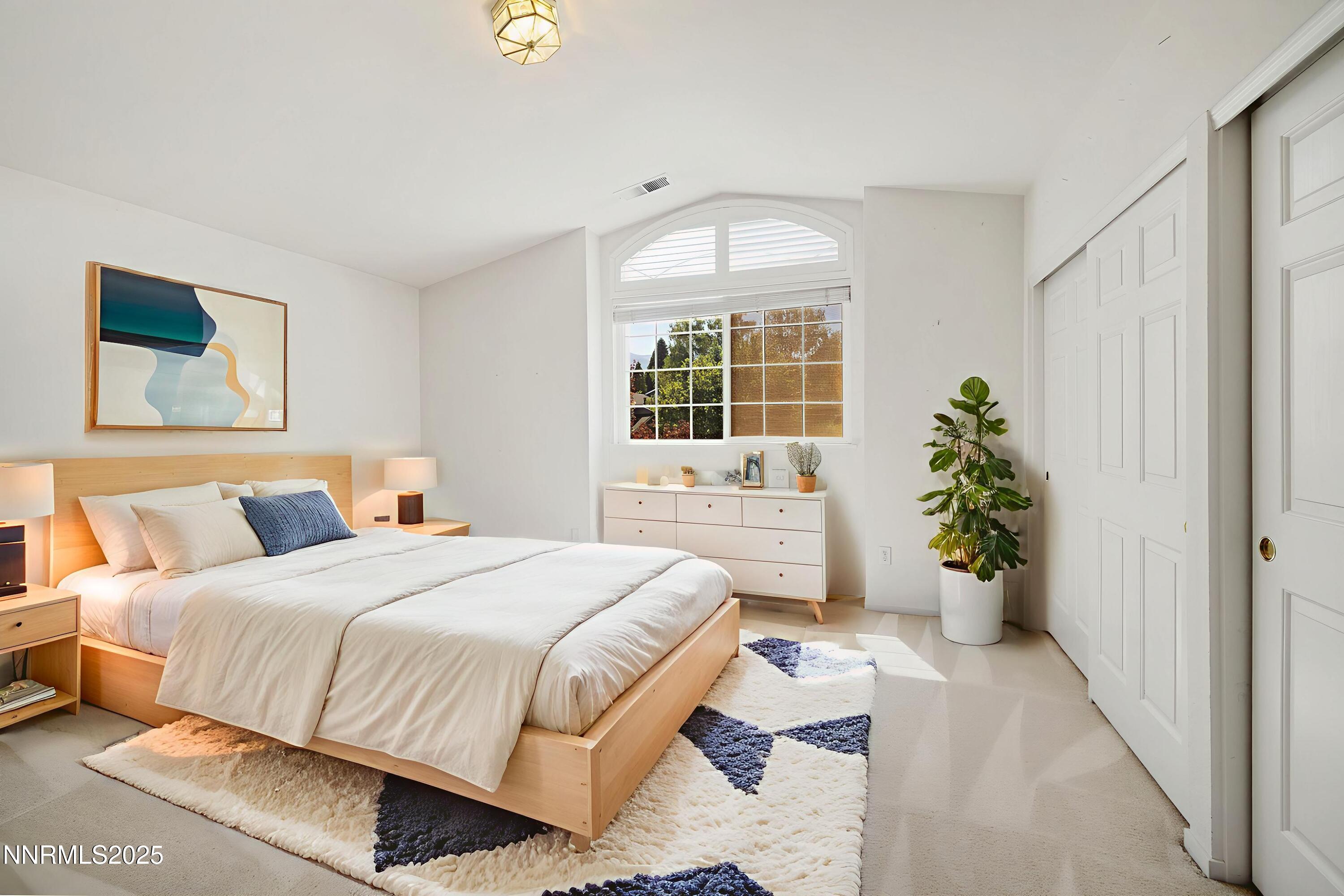 14330 Ghost Rider Drive Reno, NV 89511 - Photo 20 of 41 a bedroom with a bed and a potted plant