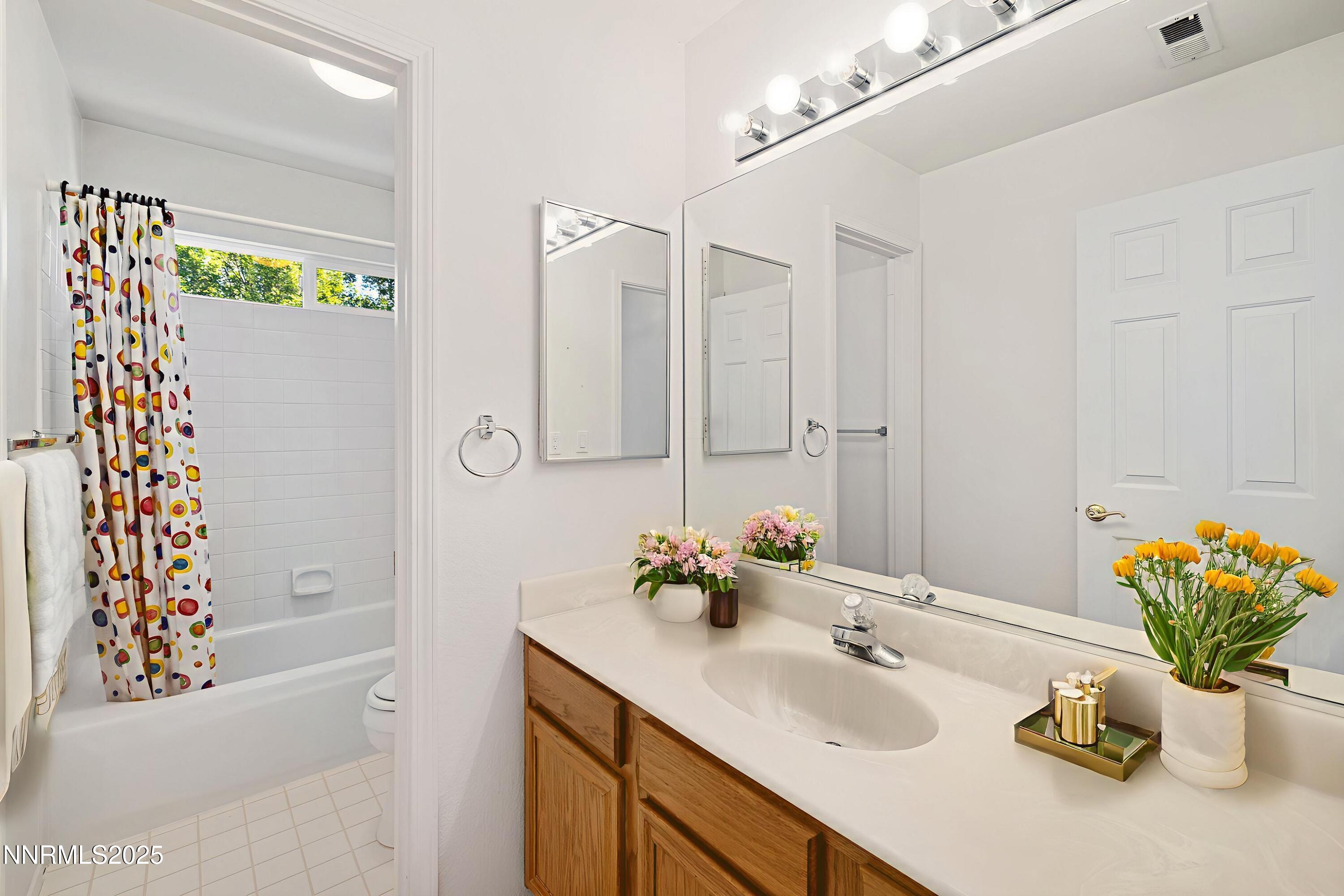 14330 Ghost Rider Drive Reno, NV 89511 - Photo 21 of 41 a bathroom with a sink a vanity and a mirror