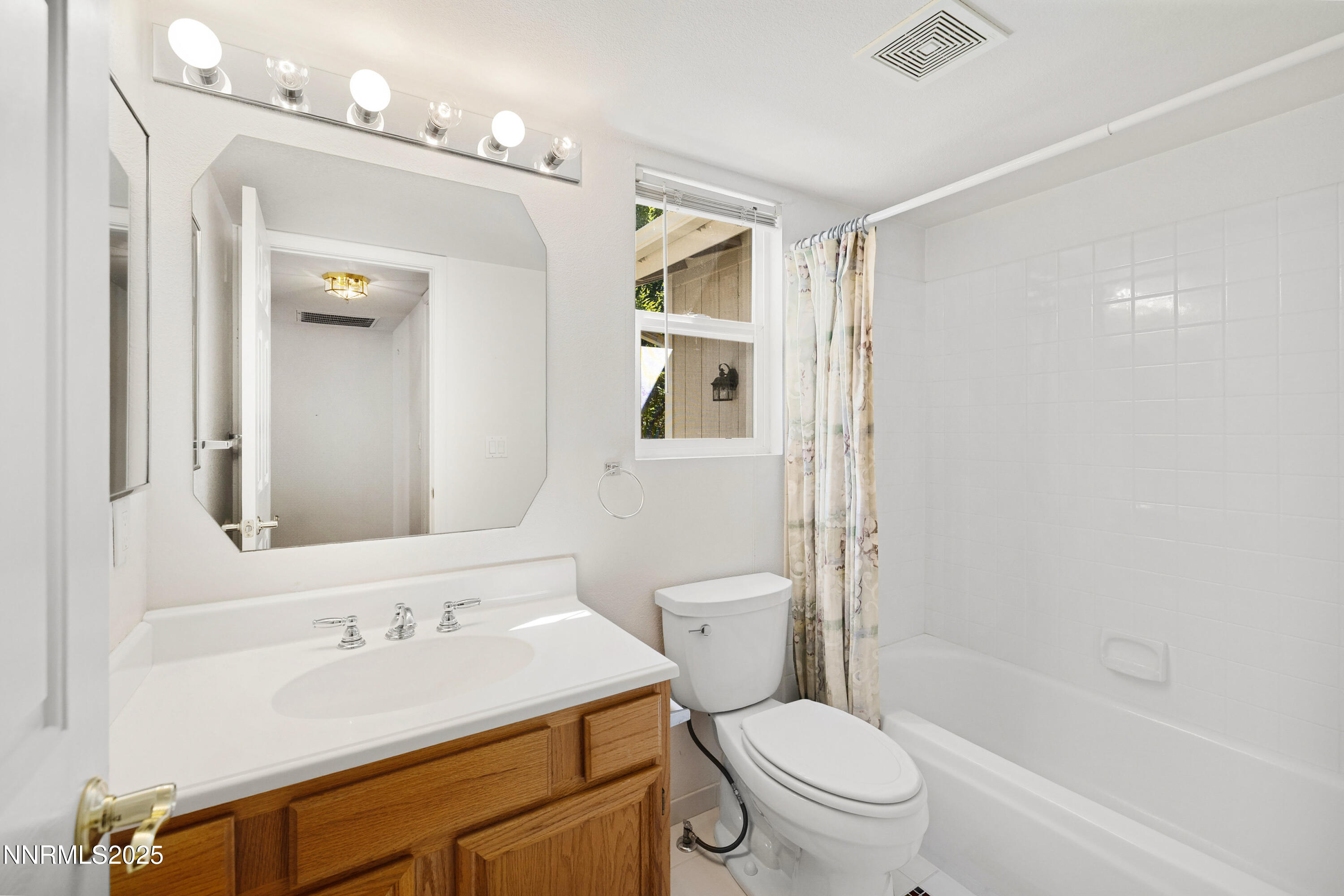 14330 Ghost Rider Drive Reno, NV 89511 - Photo 24 of 41 a bathroom with a sink a toilet a mirror and shower