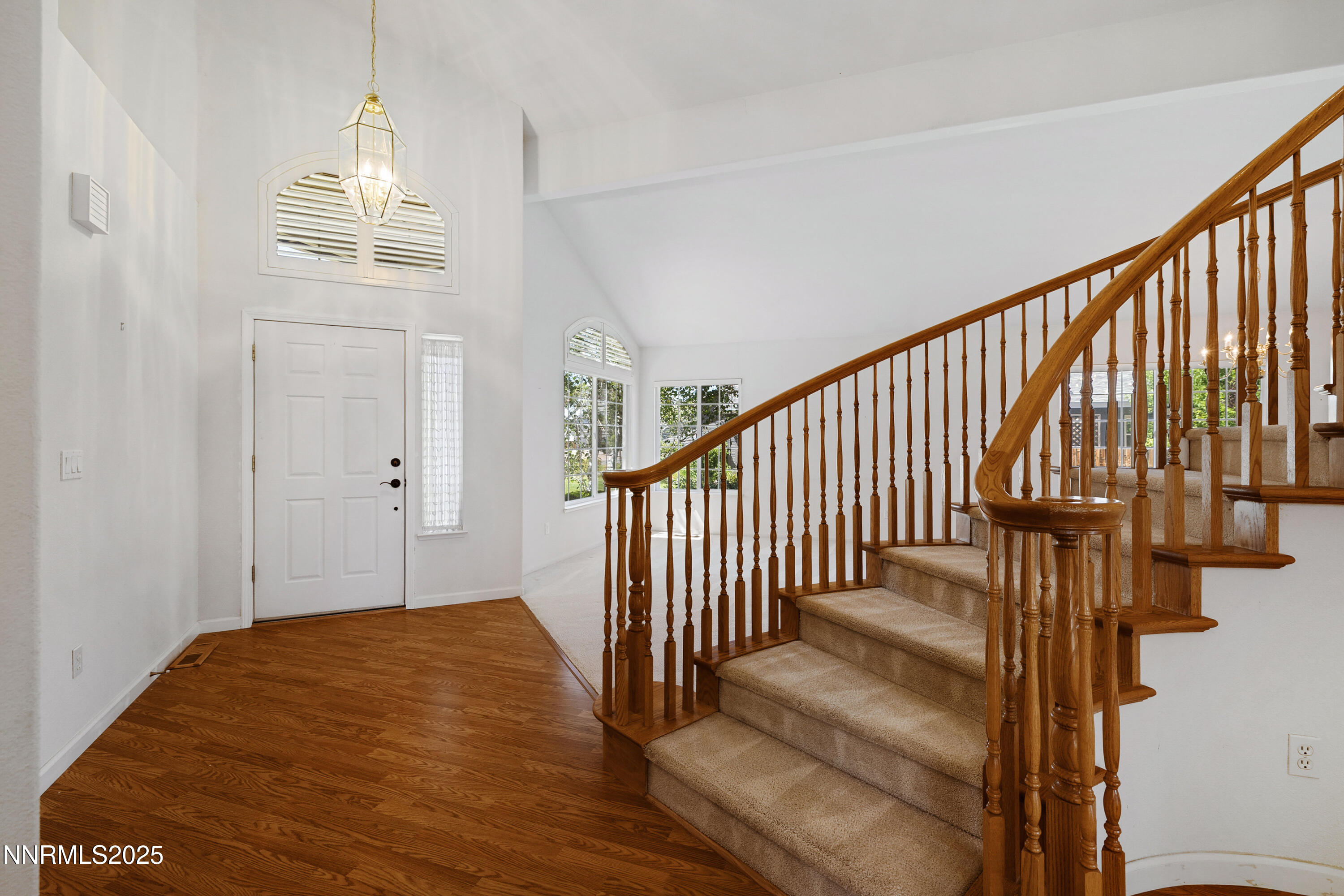 14330 Ghost Rider Drive Reno, NV 89511 - Photo 3 of 41 a view of a hallway with wooden floor and staircase