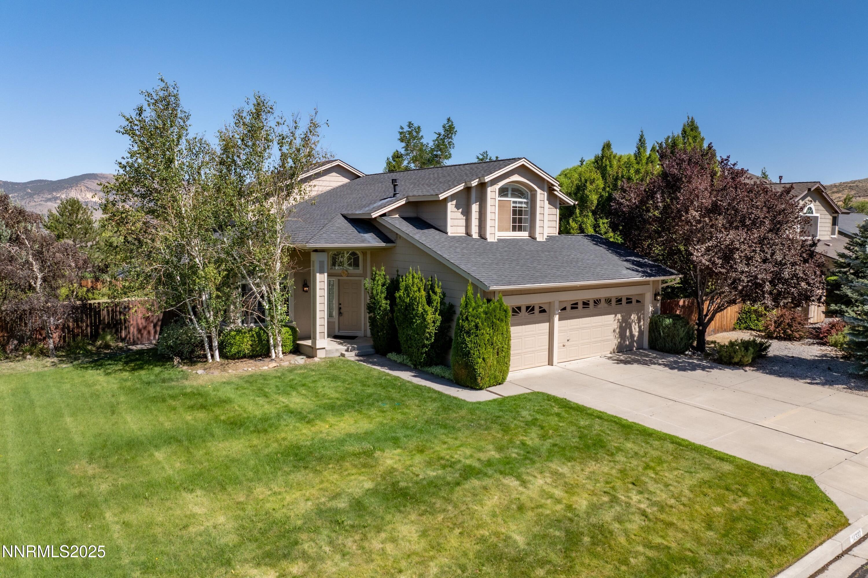 14330 Ghost Rider Drive Reno, NV 89511 - Photo 35 of 41 a front view of a house with a yard and garage