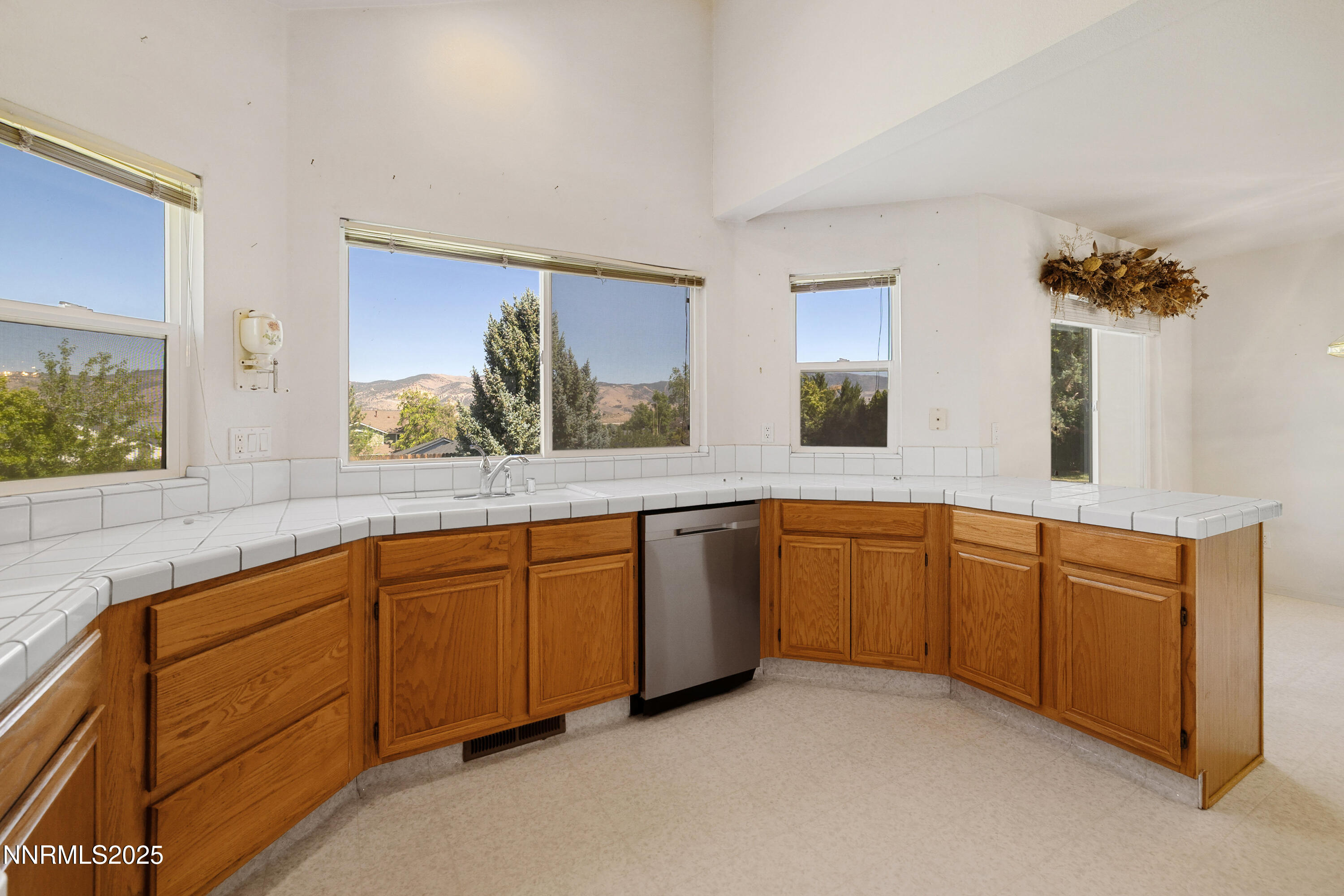 14330 Ghost Rider Drive Reno, NV 89511 - Photo 10 of 41 a large white kitchen with sink and window