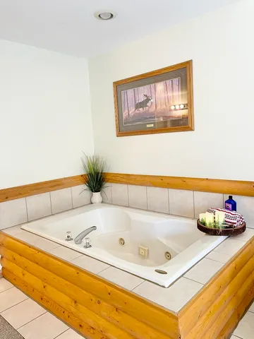 a bathroom with a tub and sink