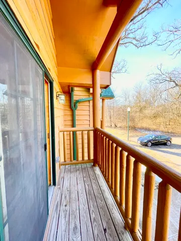a view of balcony with wooden floor and fence