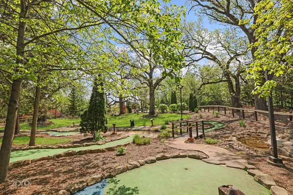a view of a swimming pool with a patio and a yard