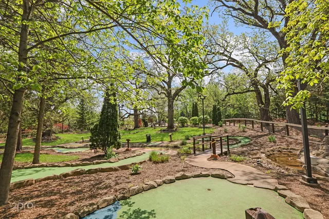 a view of a swimming pool with a patio and a yard