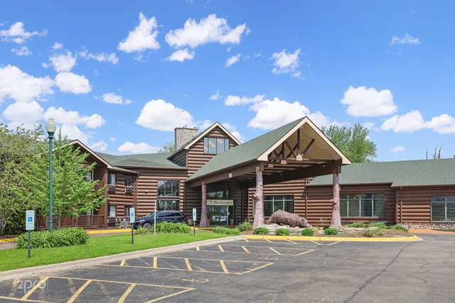 a front view of a house with a garden and plants