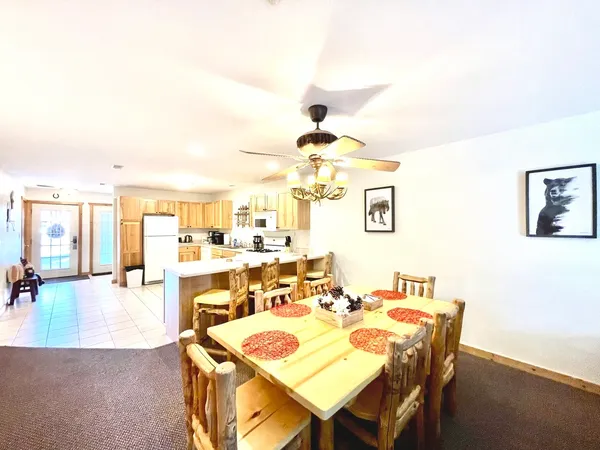 a dining room with a table and chairs