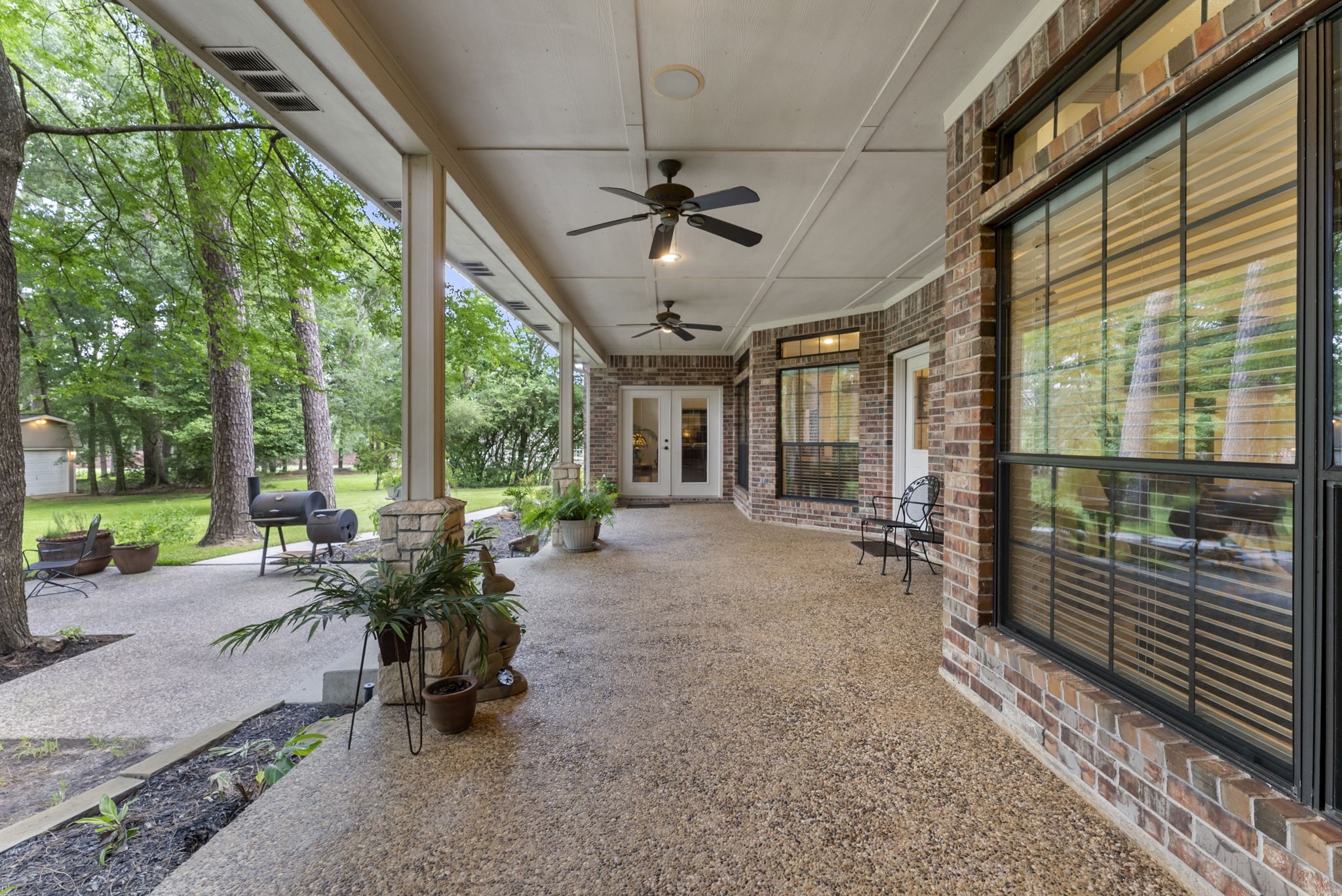 24311 Standing Oak Drive Spring, TX 77389 - Photo 37 of 42 The deep covered porch runs along the rear of the home, complete with ceiling fans and ample room for outdoor dining. It’s built for year-round enjoyment.