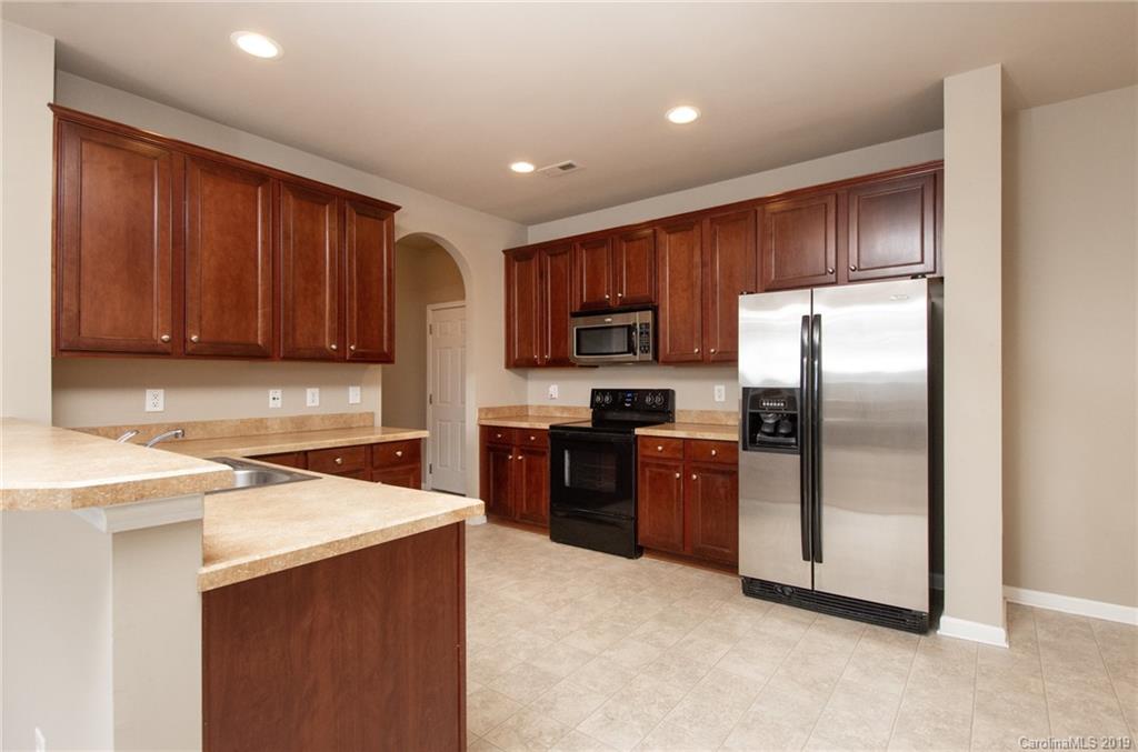 9824 Caldwell Depot Road Cornelius, NC 28031 - Photo 11 of 29 a kitchen with stainless steel appliances granite countertop a refrigerator stove a sink and dishwasher