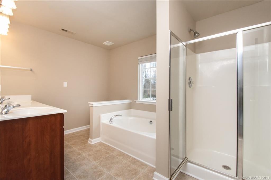 9824 Caldwell Depot Road Cornelius, NC 28031 - Photo 20 of 29 a bathroom with a bathtub and a sink