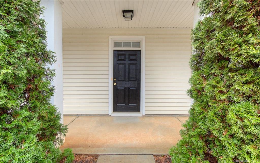 9824 Caldwell Depot Road Cornelius, NC 28031 - Photo 4 of 29 a front view of a house with a garage